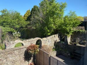a stone retaining wall with a stone bridge at 10 Crickhowell Cottages, Standard Street, Central Crickhowell in Crickhowell