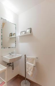 a white bathroom with a sink and a mirror at PISO CON TERRAZA in Ribadeo