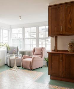 a living room with two chairs and a table at PISO CON TERRAZA in Ribadeo