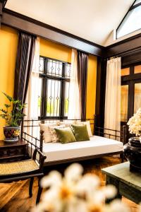 a living room with a couch and a window at Baannaisuk Pool Villa in Ban Mae Pu Kha +34 photos