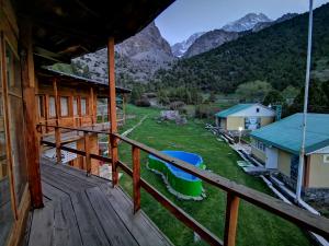 a view from the deck of a cabin with mountains in the background at Artuch Camp - Fan Mountains in Yakkakhona