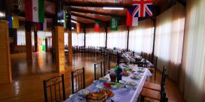 a long dining room with tables with food on them at Artuch Camp - Fan Mountains in Yakkakhona