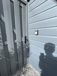 a metal garage door with a plant next to it at Vakantie Studio Mari Jani in Waterlandkerkje