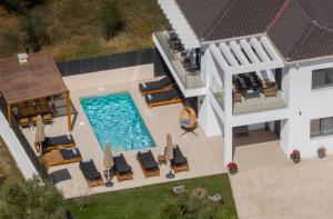 an aerial view of a house with a swimming pool at Villa Dreamscape - Elegant Stay with Private Pool by Villa Mana Gers in Planos
