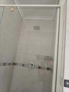a shower with a glass door in a bathroom at Stay with Tayo in Kempton Park