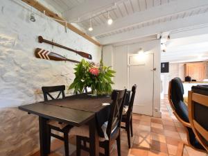 a dining room with a wooden table and chairs at Brittany Escape with Garden in Kersaudy