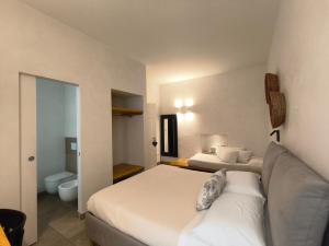 a hotel room with two beds and a couch at La Maison in Trani