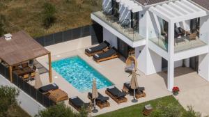 an aerial view of a house with a swimming pool at Villa Dreamscape - Elegant Stay with Private Pool by Villa Mana Gers in Planos