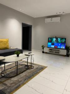 a living room with a couch and a tv at Home apartment 2 in Medina