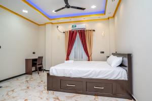 a bedroom with a bed and a desk in it at RR complex in Trincomalee
