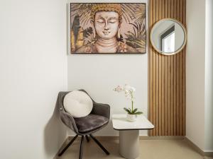 a room with a chair and a mirror and a table at Villa Dreamscape - Elegant Stay with Private Pool by Villa Mana Gers in Planos