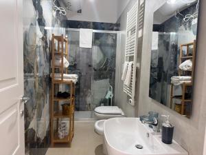 a bathroom with a sink and a toilet and a shower at Terrazza Vanvitelli in Caserta +32 photos