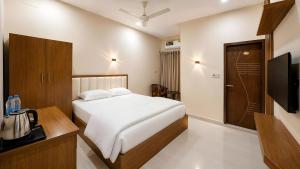 a hotel room with a bed and a television at Hotel Grand Darbar in Barisāl