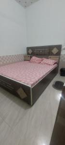 a bed in a room with a pink mattress at Hotel KANHA in Karauli