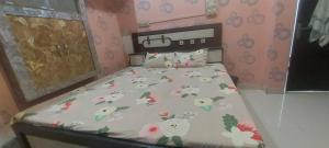 a small bedroom with a bed with flowers on it at Hotel KANHA in Karauli