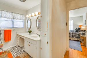 a bathroom with a sink and a bedroom at Highly Walkable Area! Charming Roswell Bungalow in Roswell +21 photos