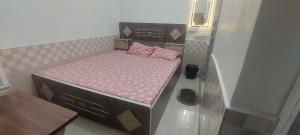 a small bed in a small room at Hotel KANHA in Karauli +8 photos