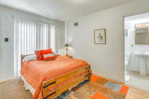 a bedroom with a bed and a bathroom with a sink at Highly Walkable Area! Charming Roswell Bungalow in Roswell