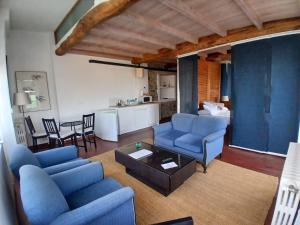 a living room with blue couches and a table at NAMOR-Estudio Galeria in Ribadeo