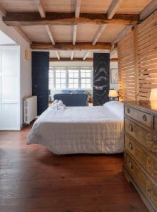 a bedroom with a large bed with a wooden ceiling at NAMOR-Estudio Galeria in Ribadeo