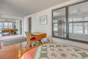 a bedroom with a bed and a desk and a table at Highly Walkable Area! Charming Roswell Bungalow in Roswell