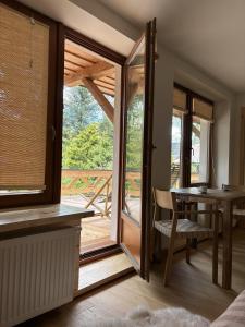 a room with a glass door leading to a deck at Willa Mitia in Zakopane