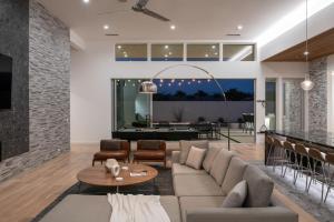 a living room with a couch and a table at Mercury @ Elemento49 - Pool Spa - Sleeps 16 in Indio