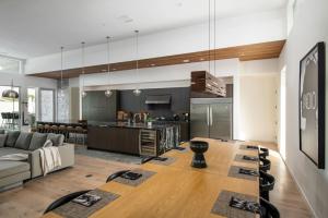an open kitchen and living room with a couch and a table at Mercury @ Elemento49 - Pool Spa - Sleeps 16 in Indio