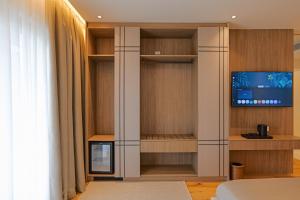 a living room with a tv in a closet at CITADEL Heritage Hotel Berat in Berat