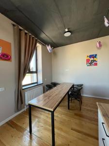 a dining room with a wooden table and chairs at Hostel 78 in Karakol