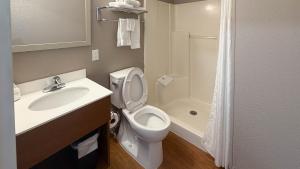 a bathroom with a toilet and a sink and a shower at Studio 6 Rancho Cordova, CA in Rancho Cordova +17 photos
