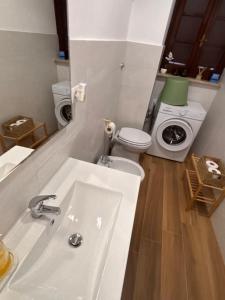 a bathroom with a white sink and a toilet at De Chri House in Cisterna di Latina +20 photos