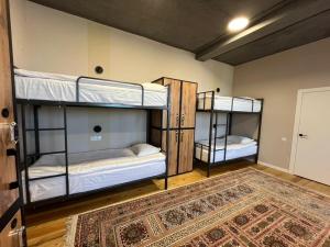 two bunk beds in a room with a rug at Hostel 78 in Karakol +7 photos