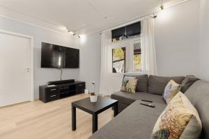 a living room with a couch and a table at Home and Away in Vaksdal