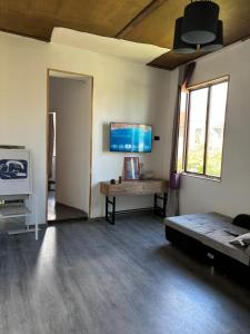 a living room with a couch and a table and a tv at Guesthouse Story in Lagodekhi in Lagodekhi