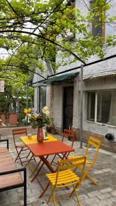 a patio with a table and chairs in front of a building at Guesthouse Story in Lagodekhi in Lagodekhi