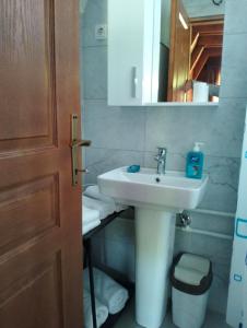 a bathroom with a white sink and a mirror at RIVERSTONE Drašković camp and bungalows in Nikšić