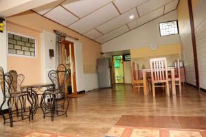 a living room with a table and chairs at Sunshine retreat in Coonoor