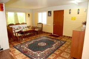a room with a table and a rug on the floor at Sunshine retreat in Coonoor
