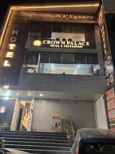 a building with stairs in front of a store at Crown Palace Hotel & Restaurant in Hāpur