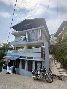 a motorcycle parked in front of a building at Adarsh villa in Dharmsāla