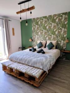 a bedroom with a bed made out of logs at L'Orée du Bois in Pulnoy