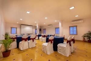a banquet hall with blue and white tables and chairs at Fort JadhavGADH -A GADH Heritage Hotel in Pune +208 photos