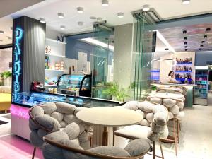 a restaurant with tables and chairs and a counter at Palotel Gouvia Hotel in Gouvia