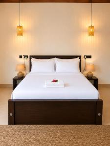 a bedroom with a bed with a flower on it at Myla Lodge in Anuradhapura +12 photos
