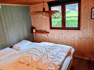 a bedroom with a bed and a window at Chalet La Roche 231 in Rendeux