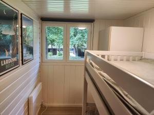 a small room with a bed and a window at Chalet La Roche 231 in Rendeux