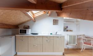 a kitchen with a sink and a microwave at NAMOR - Buhardilla Zen in Ribadeo +7 photos
