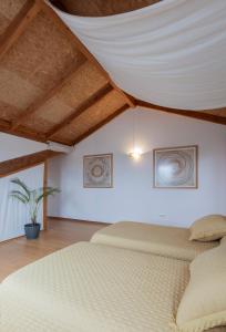 a bedroom with two beds and a ceiling at NAMOR - Buhardilla Zen in Ribadeo