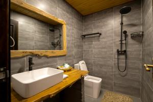 a bathroom with a sink and a shower at 唐韵驿馆 in Dunhuang +47 photos